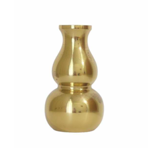 A shiny, gold-colored metal vase with a bulbous base and a narrow neck.